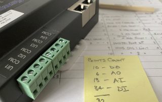 Image of an EasyIO controller with hand written point schedule